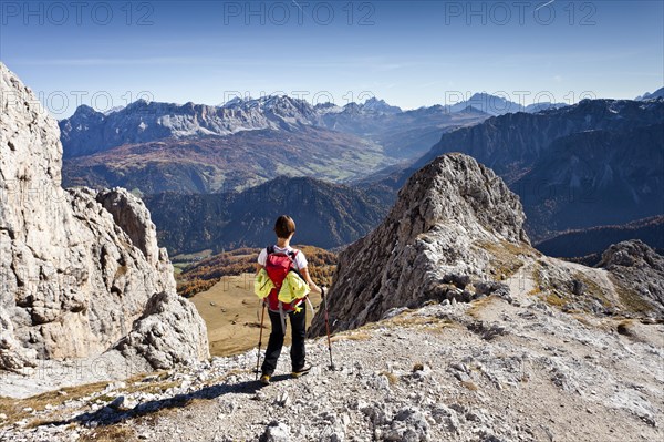 Mountain climber descending from Peitlerkofel Mountain in Puez-Geisler Nature Park