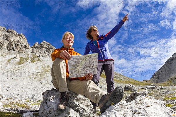 Two women reading map of trails