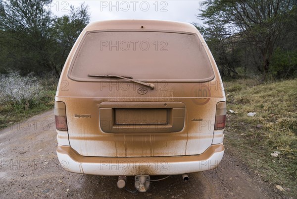 Dusty car on on a gravel road