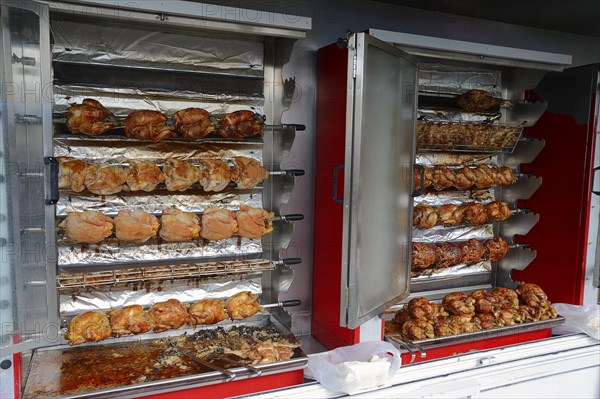 Market stall with a chicken grill and fried chicken