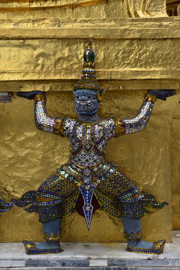 Guardian figure on a golden chedi