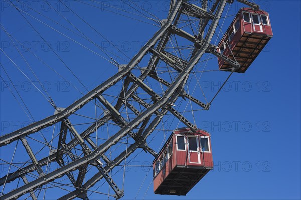 Two cabins of the Wiener Riesenrad ferris wheel against a blue sky at the Prater