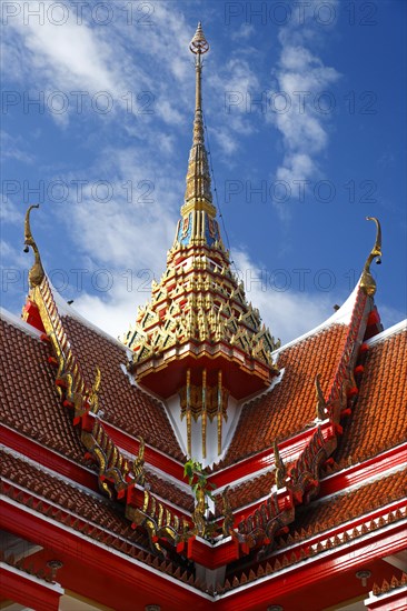 Red roof of a pagoda with an ornate spire