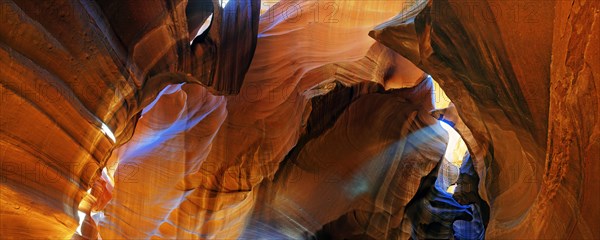 Rays of light falling on yellow-red sandstone formations