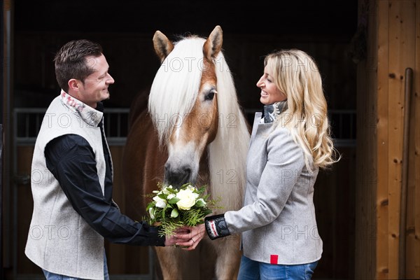 Man giving a woman flowers