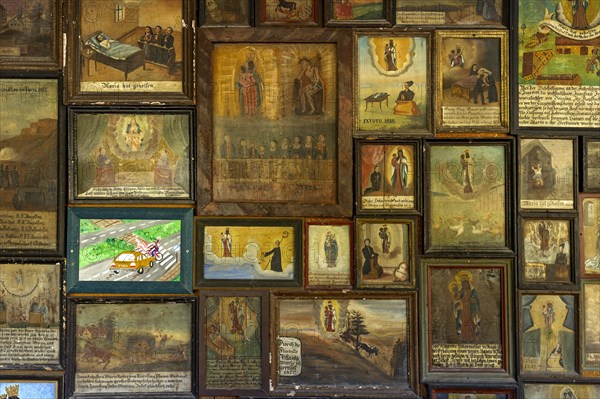 Old and newer votive offerings in the cloister around the Shrine of Our Lady of Altotting