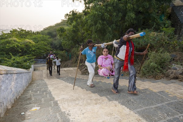 Porters carrying Jain pilgrims up Mount Shatrunjaya