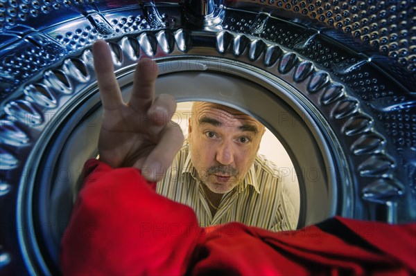 Man looking into a washing machine