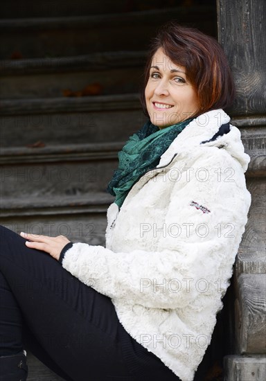 Smiling woman sitting on stairs