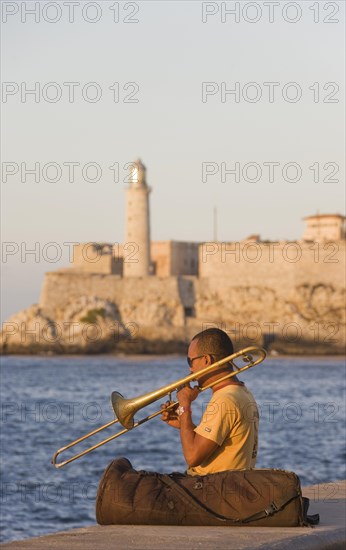 Musician playing the trombone at the Malecon esplanade