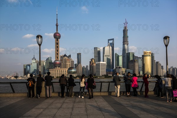 Tourists in front of the Pudong skyline with Oriental Pearl Tower