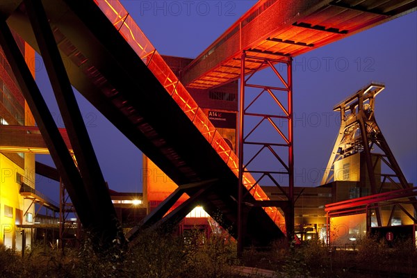 Illuminated gangway to the Ruhr Museum at the Zeche Zollverein Coal Mine Shaft XII with the headframe