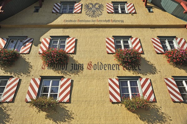 Shingle facade with windows and flower boxes