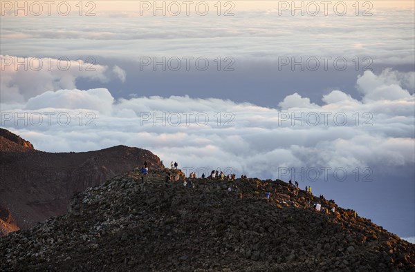 Tourists on the summit of the Haleakala volcano at sunrise