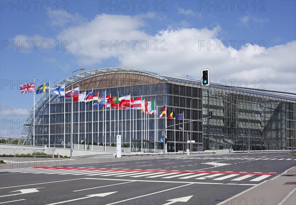 International flags waving in front of European Investment Bank