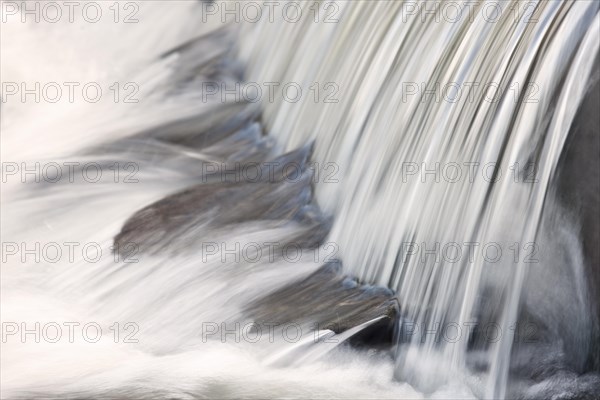 Mountain stream with small waterfall