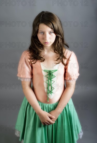 Girl wearing an old-fashioned dress looking sad