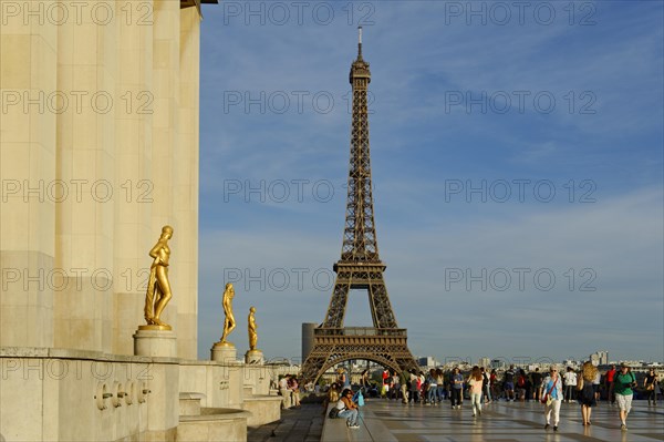 Golden statues at the Palais de Chaillot with the Eiffel Tower