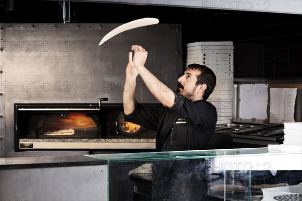 Pizza baker preparing the pizza dough