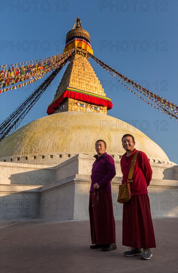 Two monks walking around Boudhanath stupa