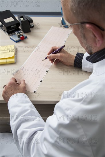 Doctor checking an ECG finding