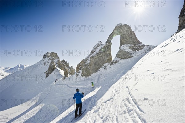 Skiers and snow-covered mountains