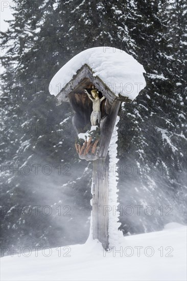 Wayside shrine during a snowstorm