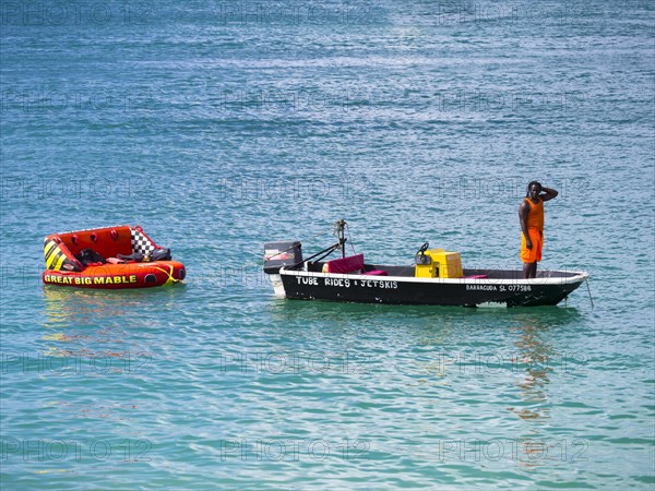 Man hiring out boats waits for customers