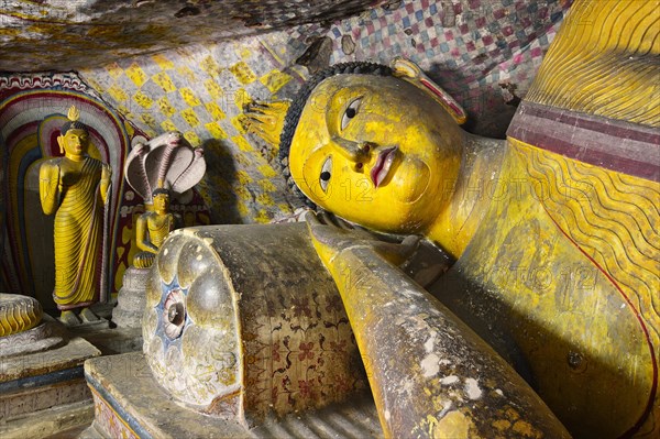 Buddha statues and murals in one of the cave temples of the Golden Temple