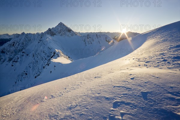 Frozen north face of Reitherspitze Mountain in the last sunlight