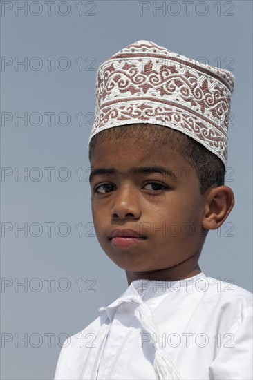 Omani boy wearing a traditional cap called a Kummah