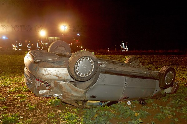 Car which has strayed from the road and rolled over onto its roof