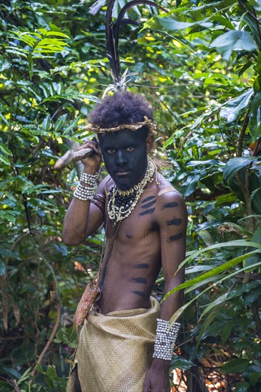 Traditional dressed man holding a spear