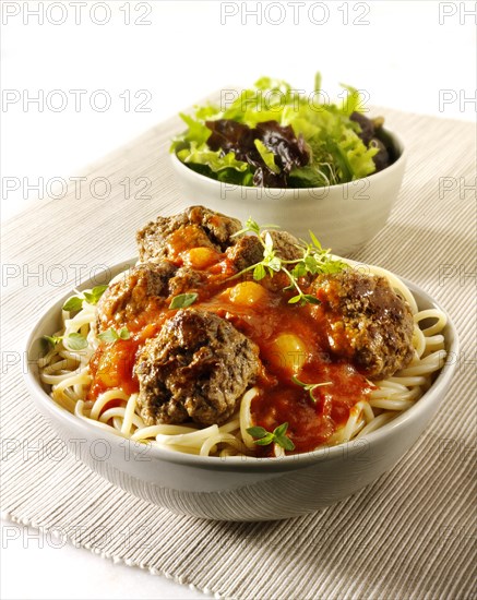 Meat balls on spaghetti with a tomato