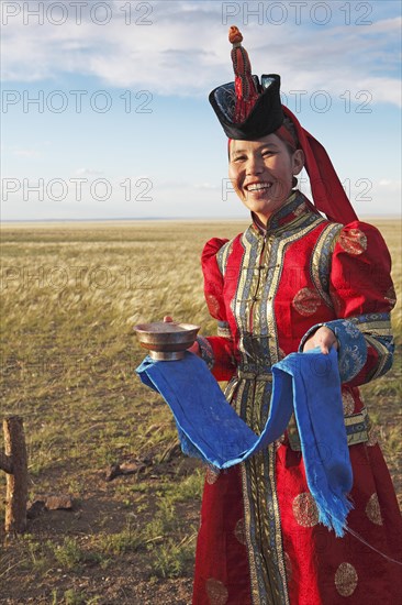 Woman in traditional dress with traditional welcome utensils