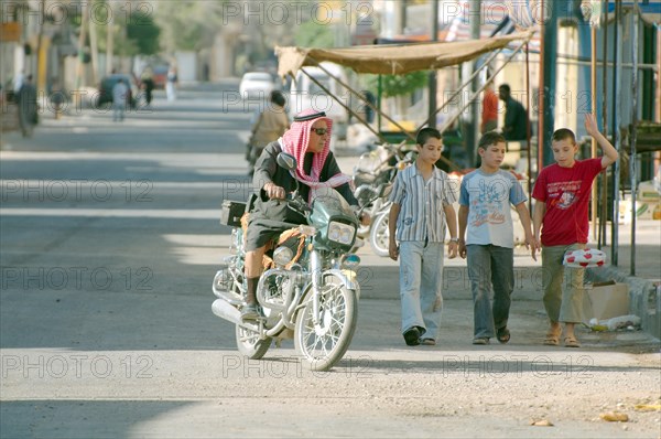 Motorcyclist riding down the street