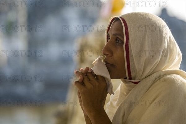 A Jain nun praying at a temple