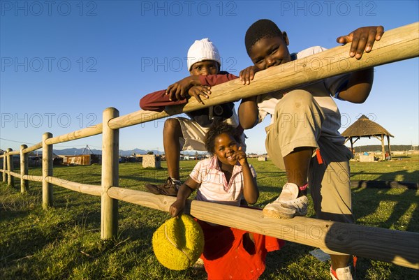 Two boys and a girl with a ball