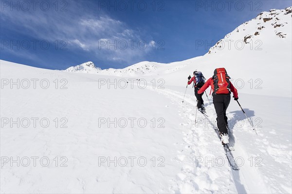 Ski tourers climbing Stotz mountain