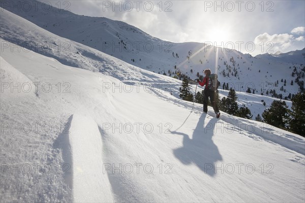 Woman during the ascent above the tree line on a ski tour