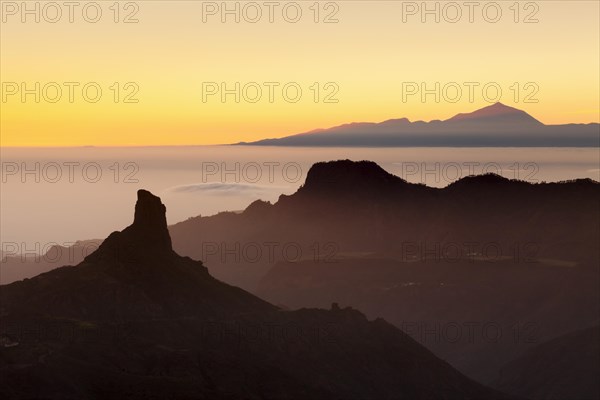 Rock formation of Roque Bentayga in front of Tenerife with Mount Teide