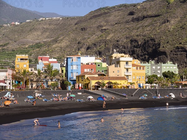 Tourists on the black beach of Puerto de Tazacorte