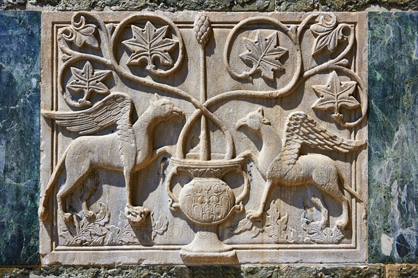 Medieval Oriental Byzantine bas-relief of two winged griffins on the facade of St Mark's Basilica