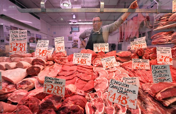 Butcher behind his display