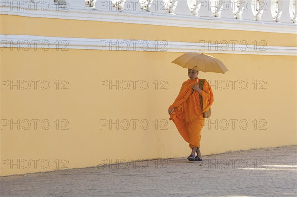 Buddhist monk walking along the walls of the Royal Palace