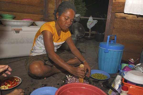 Papuan woman preparing food