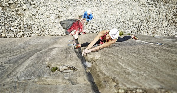 Woman lead climbing a gully