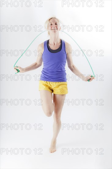 Woman in sportswear jumping rope