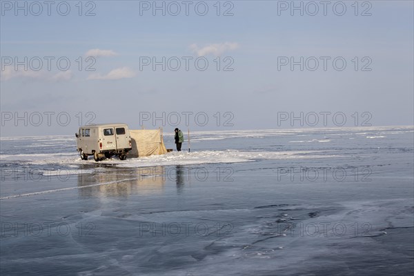 Fishermen fishing on the frozen Lake Baikal