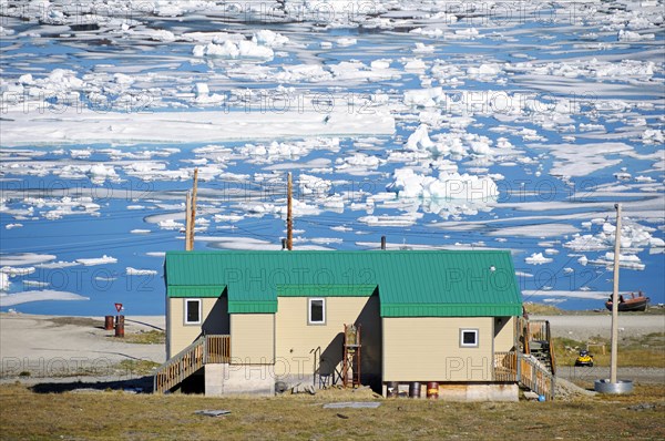 House of the Inuit people in the village of Ulukhaktok with ice floes in the Beaufort Sea